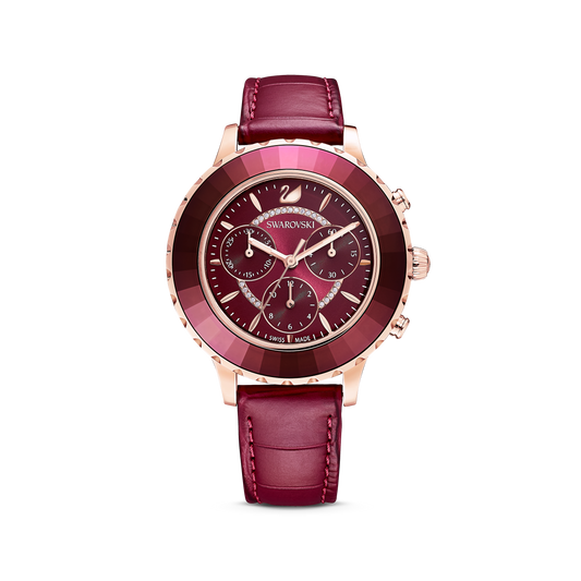 The Octea Lux Chrono watch by Swarovski is a luxury timepiece featuring a Swiss-made design with a deep red leather strap and matching red dial. It includes rose gold-tone accents, three chrono subdials, and a patterned stainless steel bezel that proudly displays the "Swarovski" brand name.