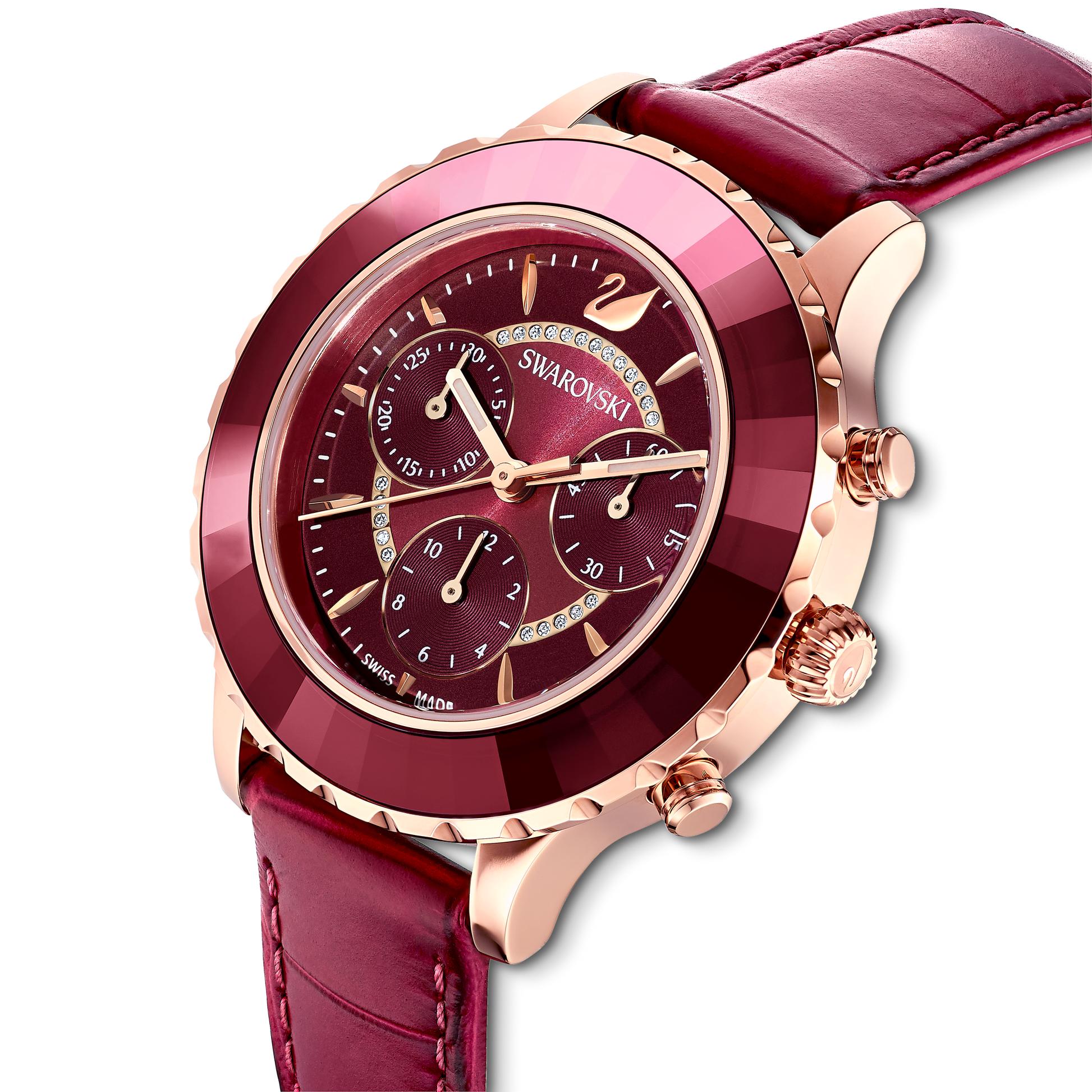 Featuring a red leather strap and a rose gold-tone case, the Octea Lux Chrono watch by Swarovski offers an elegant design with its detailed face adorned with multiple subdials and Swarovski crystal embellishments.