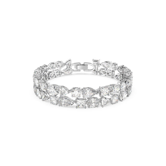 The Swarovski Mixed Cuts Tennis Deluxe Bracelet showcases a stunning array of sparkling stones, combining large pear-shaped and round cuts set in a silver band, complete with a secure clasp.