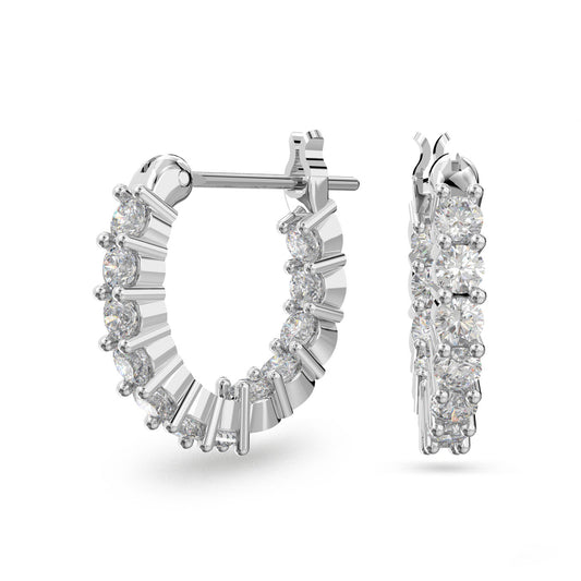 The Swarovski Vittore Hoop Earrings from the renowned brand Swarovski are embellished with tiny, radiant white stones set in a circular design that beautifully reflects light and highlights intricate details. These stunning earrings are presented against a simple white background.