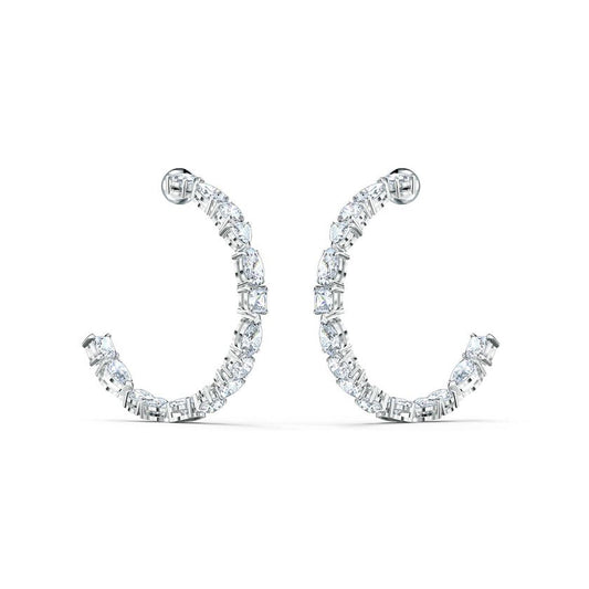The Swarovski Tennis Deluxe Mixed Hoop Pierced Earrings, crafted by Swarovski, are adorned with brilliant Swarovski zirconia in a symmetrical design, showcased against a simple white backdrop. These earrings embody a refined and sophisticated style.
