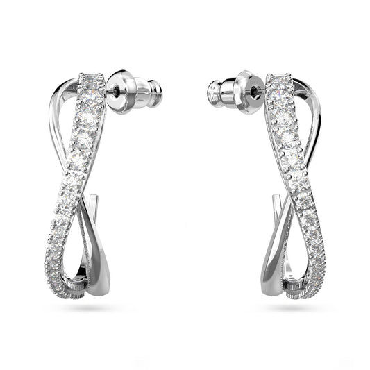 The Swarovski Twist Hoop Earrings feature a sleek and modern design with an infinity shape, adorned with embedded white stones that glisten elegantly.