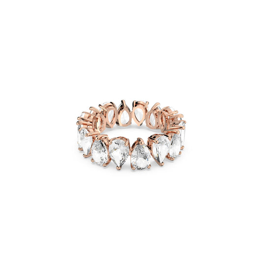 The Swarovski Vittore Drop Cut Ring is a rose gold eternity ring that showcases faceted pear-shaped clear gemstones arranged in a seamless row along the band. This elegant design features each gemstone securely held in prongs, making it ideal for trendy stacking looks against a plain white background.