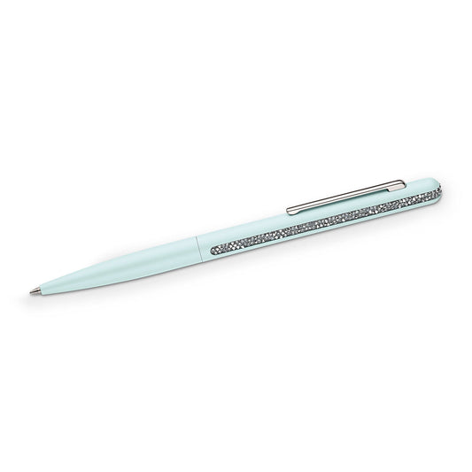 The Swarovski Crystal Shimmer Ballpoint Pen showcases a sophisticated light blue design complemented by a silver clip and a sparkling band of crystals, meticulously crafted with the Crystal Rocks technique. Set diagonally against a plain white background, it radiates elegance and style.