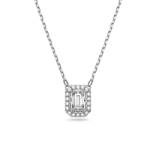 The Swarovski Millenia Octagon Cut Necklace by Swarovski features an octagon-shaped pendant with a central emerald-cut diamond, surrounded by smaller round diamonds. The necklace boasts a delicate, thin link design chain that is rhodium-plated, enhancing the elegant and luxurious appeal of the pendant.