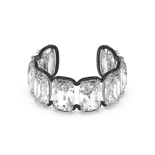 A detailed view of the Swarovski Oversized Floating Crystals Harmonia Cuff by Swarovski, showcasing several large cushion-cut crystals set in a silver band. The crystals exhibit stunning facets and clarity, reflecting light beautifully with the mesmerizing allure characteristic of Swarovski designs.