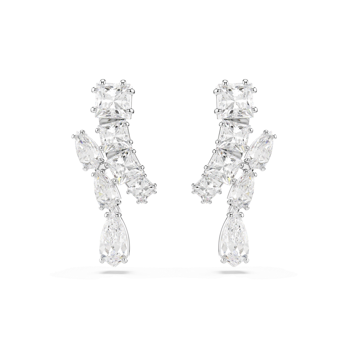 A pair of Swarovski Matrix drop earrings in white, rhodium plated, featuring a mix of clear, differently shaped gemstones arranged vertically, displayed on a plain white background.