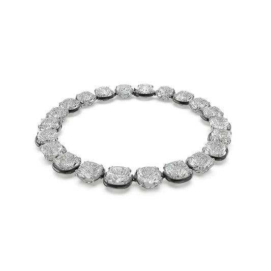 The Swarovski Cushion Cut Harmonia Choker is a luxurious piece featuring a continuous row of sparkling Swarovski crystals, perfectly set in a sleek choker design. This exquisite accessory complements any jewelry collection, radiating elegance against a plain white background.