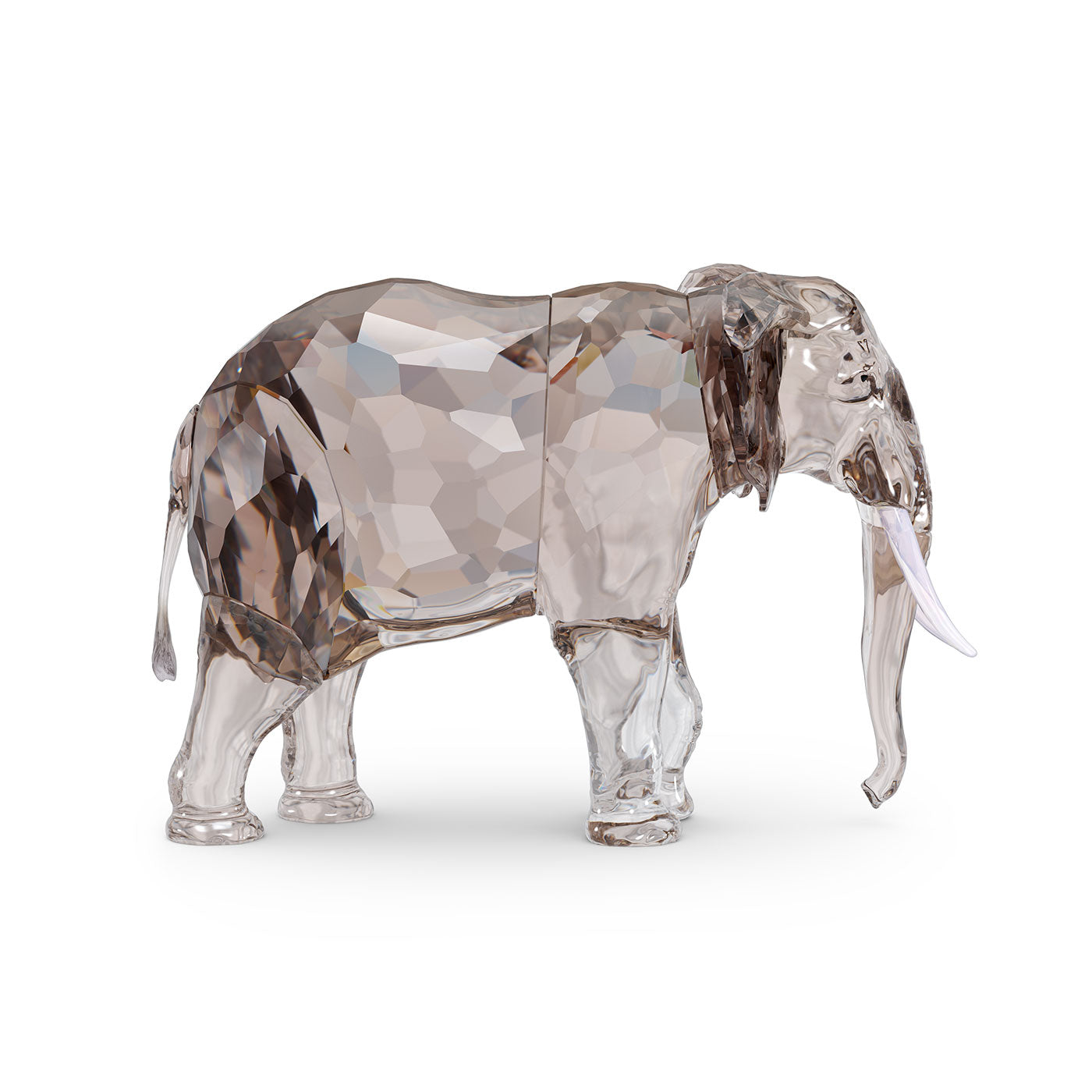 As part of the Swarovski Elegance of Africa SCS Annual Edition 2022, this Fayola Home Décor piece is a stunning figurine of an elephant. It features a shimmering greige crystal design with a faceted body, smooth trunk, and detailed tusks that beautifully blend transparent and reflective surfaces.