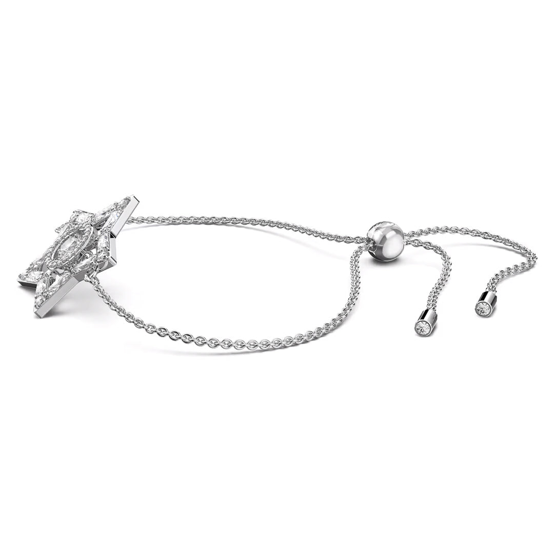 Introducing the Swarovski Stella Bracelet: A delicate silver piece featuring a dancing stone set within a star-shaped charm encrusted with tiny diamonds. This bracelet is designed with an adjustable sliding closure that includes two dangling ends, each adorned with a small gem.
