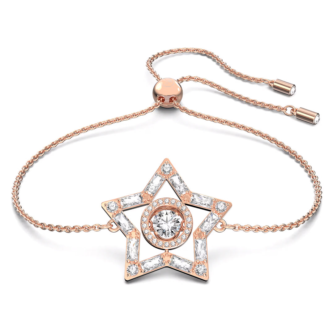 Part of the Swarovski Stella Collection, this rose gold-tone bracelet showcases a star-shaped pendant adorned with clear gemstones. At the center of the star is a larger round gemstone. The bracelet includes an adjustable chain with sliding bead clasps to ensure the perfect fit.