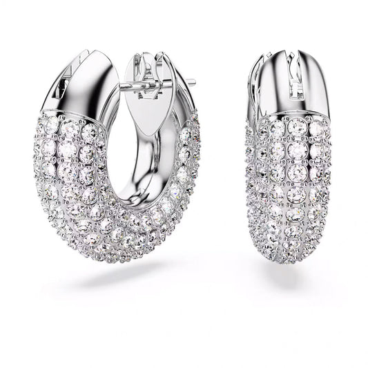 The Swarovski Dextera Hoop Earrings, from the renowned brand Swarovski, feature a polished silver finish adorned with multiple rows of dazzling clear crystals. Their rhodium-plated construction showcases a rounded, chunky design with a secure clasp at the top that brilliantly reflects light.
