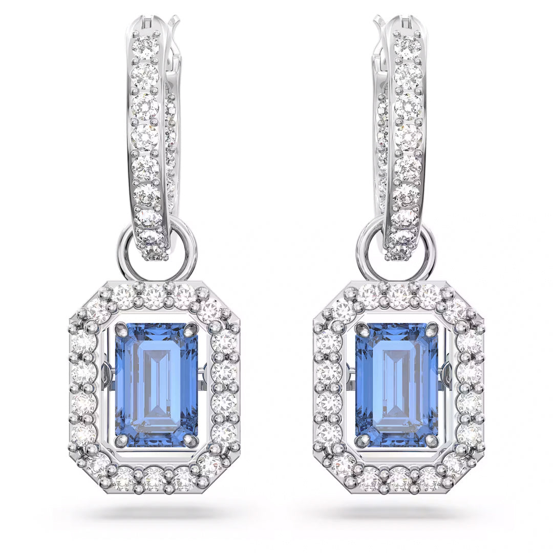 The Swarovski Una Drop Earrings from Swarovski feature blue dancing stone gemstones encircled by a halo of small, clear stones. These rhodium-plated earrings elegantly hang from hoops embellished with white pavé crystals, adding a sparkling touch to any ensemble.