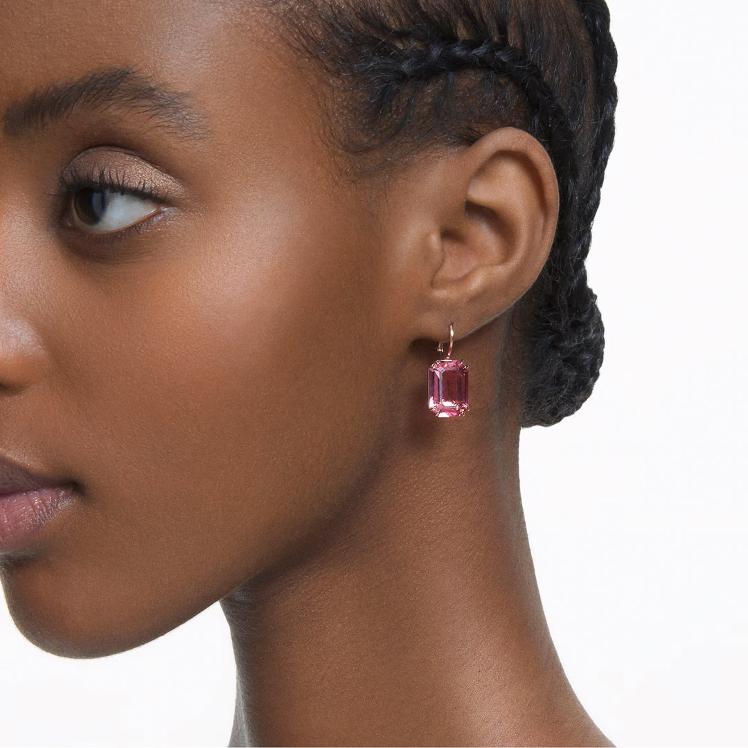 Close-up of a person wearing Swarovski Millenia Drop Earrings. The rose gold-tone plated setting beautifully complements the person's braided hairstyle, with the image focusing on the left side of their face.