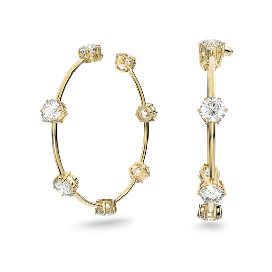 The Swarovski Round Cut Constella Hoop Earrings feature gold-tone plating and are adorned with large, round-cut zirconia clusters evenly spaced around the circumference. This minimalist design offers a sleek and elegant appearance, showcasing luxurious sophistication.