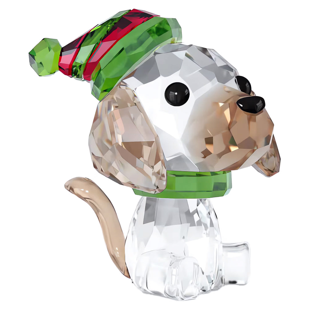 Introducing the Swarovski Holiday Cheers Beagle Home Décor by Swarovski: a stunning crystal figurine of a beagle embellished with a vibrant green and red striped holiday collar and hat. This piece showcases exquisitely-cut facets, sparkling ears, a petite tail, and striking black eyes and nose.