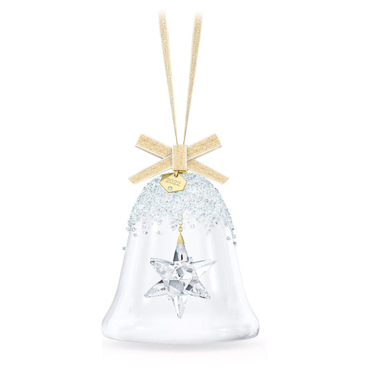 Introducing the Swarovski 2022 Annual Edition Bell Ornament, a stunning piece of home décor. Crafted from clear glass, it features a golden ribbon and an engraved "2023" tag. Inside, you'll find a beautifully sparkling star-shaped Swarovski crystal. The top is embellished with glittering beads, making this ornament a radiant addition to any holiday setting—ideal for those who appreciate timeless beauty.