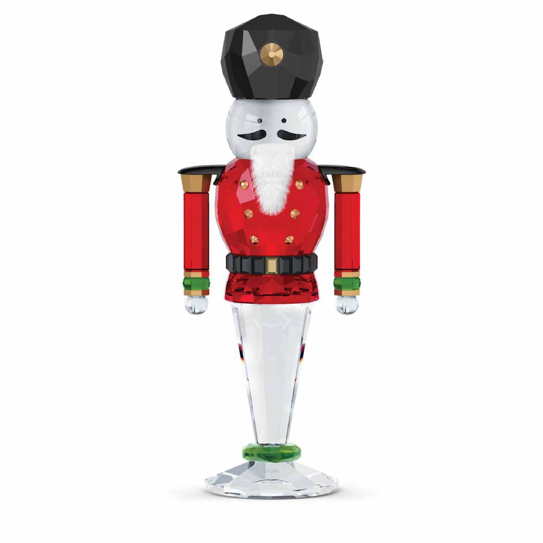 The Swarovski Holiday Cheers Nutcracker Home Décor piece, created by the renowned brand Swarovski, showcases a festive design featuring full-cut crystal craftsmanship. It highlights a striking black hat, white beard, and red uniform with elegant gold accents while standing firmly on a clear, round base.