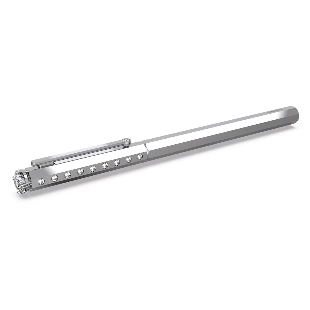The Swarovski Ballpoint Pen from Swarovski is a sophisticated silver accessory featuring dazzling gem accents along the barrel and a prominent clear crystal on the cap. Its slender, hexagonal shape combined with chrome-plated detailing enhances its sleek and contemporary look.