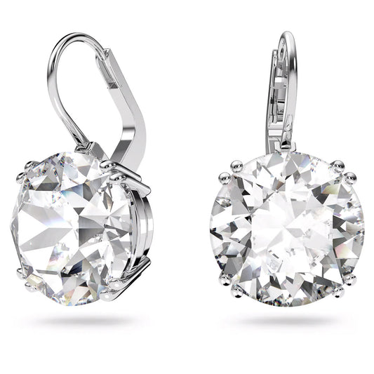 Close-up of two sophisticated drop earrings from the Swarovski Millenia collection, each adorned with a large, round-cut clear gemstone. The rhodium-plated Swarovski earrings feature a lever-back closure, highlighting their glistening and detailed design against a white background.