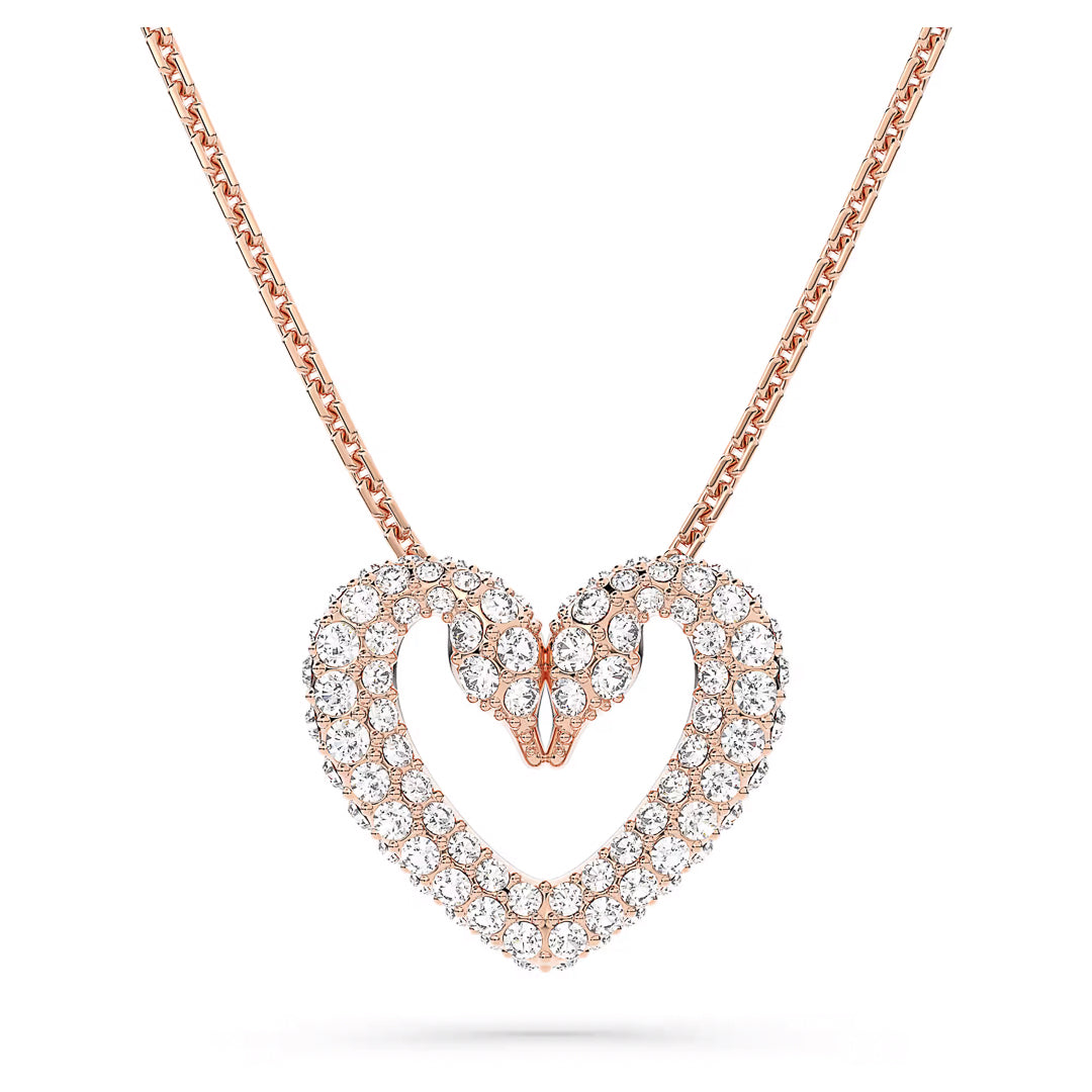 The Swarovski Sublima Necklace Pendant, crafted by Swarovski, features a rose gold-tone plated chain with two interlocking swan pendants forming a heart. These elegant swans are adorned with pavé crystals, creating a shimmering effect on the smooth chain.