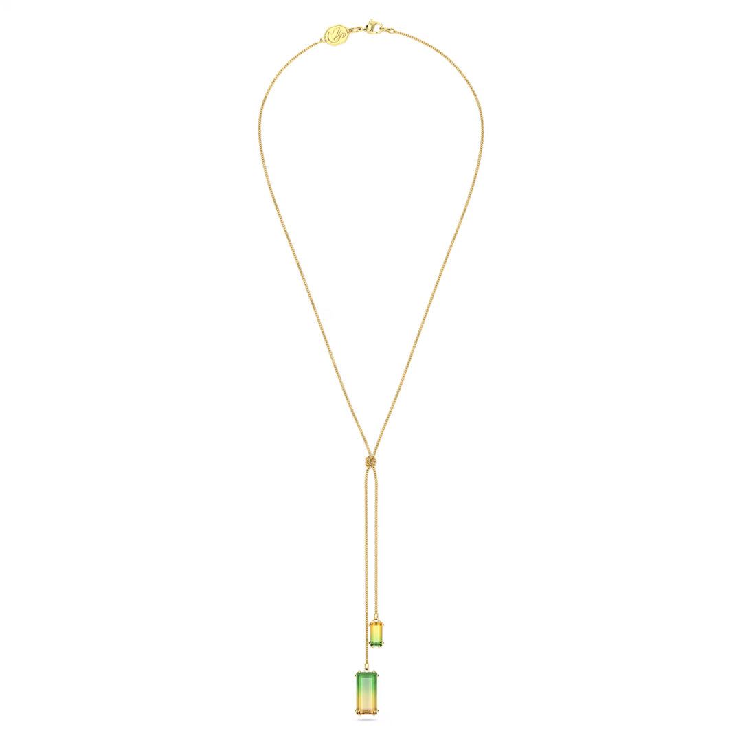 The Swarovski Millenia Y Necklace Pendant is a delicate gold-tone plated piece featuring a long pendant design adorned with two small rectangular green gemstones suspended on fine chains, perfect for those who appreciate the timeless elegance of the Millenia Family by Swarovski.