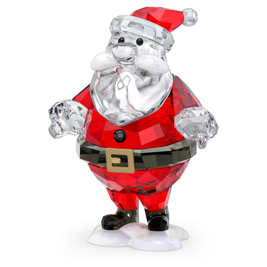 The Swarovski Holiday Cheer Santa Claus Home Décor piece features an intricately designed crystal figurine showcasing Santa adorned in a red suit, black belt, and a red hat with white trim. His beard and the details of his suit are crafted from clear crystal, perfectly capturing the festive spirit as he stands on a base that resembles snow.