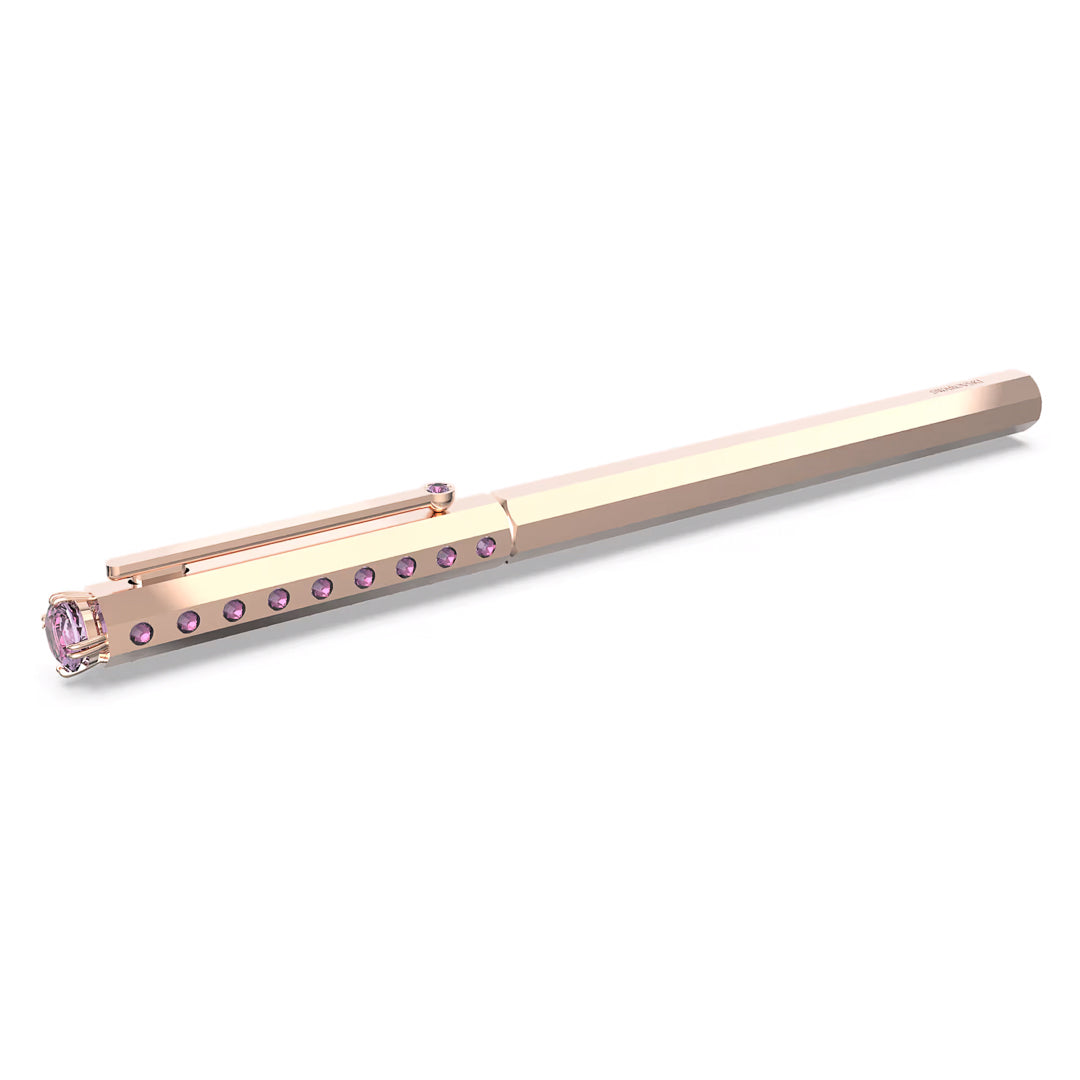 This exquisite Swarovski Ballpoint Pen by the renowned brand Swarovski features a sophisticated gold-toned barrel with a hexagonal design. Pink gemstones embellish the clip and top, enhancing the luxurious appeal of this crystal writing instrument.