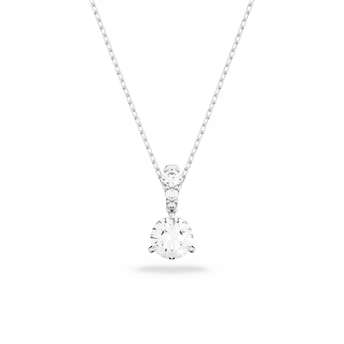 The Swarovski Solitaire Pendant Necklace White Rhodium by Swarovski features a delicate rhodium-plated chain with a single round-cut diamond pendant in a classic prong setting, elegantly showcased against a white background—an exquisite accessory that adds timeless sparkle to any occasion in Canada.