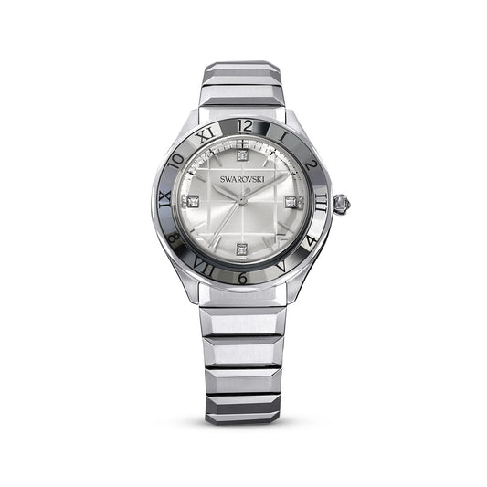 The Swarovski Dextera Quartz 37mm Watch showcases an industrial chic design with a metallic strap and round face. Roman numerals indicate the hours, complemented by crystal embellishments at the 3, 6, 9, and 12 o'clock positions. This Swiss Made timepiece features sleek silver hands that enhance its elegance.