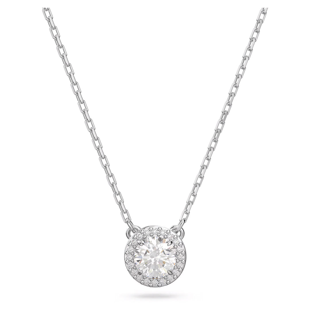 The Swarovski Una Angelic Necklace Pendant by Swarovski is a silver necklace featuring a Rhodium-plated chain with a round pendant. It showcases a large central Swarovski gemstone, surrounded by smaller Zirconia stones, creating a sparkling and elegant appearance.