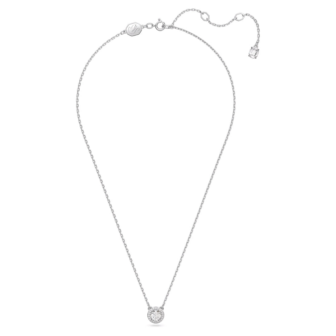 The Swarovski Una Angelic Necklace Pendant is an elegant rhodium-plated silver necklace featuring a small circular pendant adorned with a clear Swarovski zirconia gemstone. It includes an adjustable clasp and a small tag near the closure.