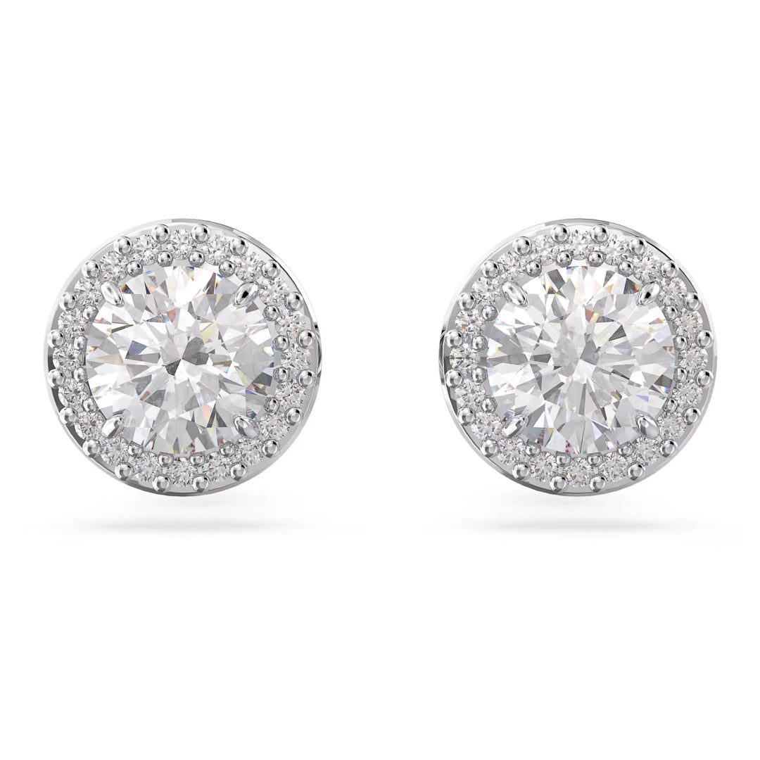 Introducing the Swarovski Una Angelic Stud Earrings by Swarovski: a stunning pair of earrings showcasing a large central diamond surrounded by a halo of smaller diamonds. These earrings are available in rhodium-plated silver or white gold, exhibiting a classic round shape. Elegantly displayed against a plain white background, they radiate with unmatched Swarovski brilliance.