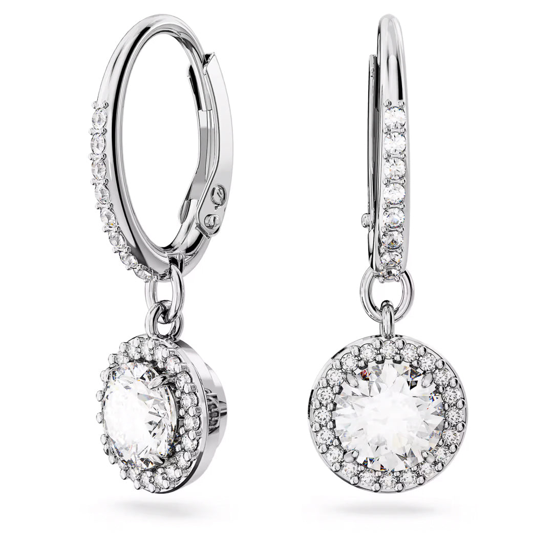 The Swarovski Una Angelic Drop Earrings feature elegant rhodium-plated silver hoops, beautifully adorned with sparkling round diamond pendants encircled by a halo of smaller diamonds. The lever-back clasps ensure secure fastening, making them perfect for any occasion.