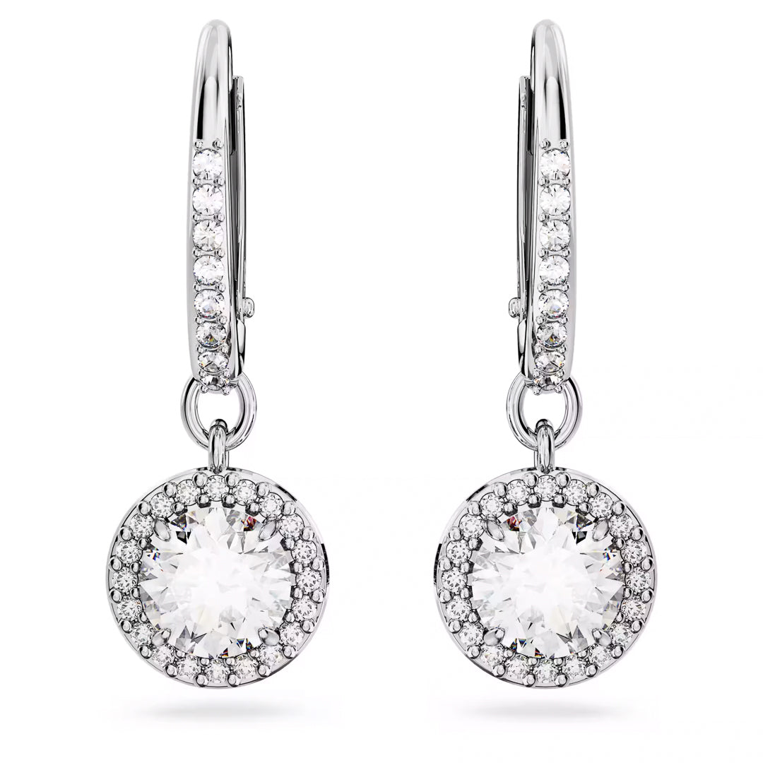 Close-up of the Swarovski Una Angelic Drop Earrings, showcasing their elegant rhodium-plated silver design. These earrings feature round, sparkling crystals surrounded by smaller stones for a stunning halo effect, while additional stones embellish the hoops to enhance their shine and sophistication.