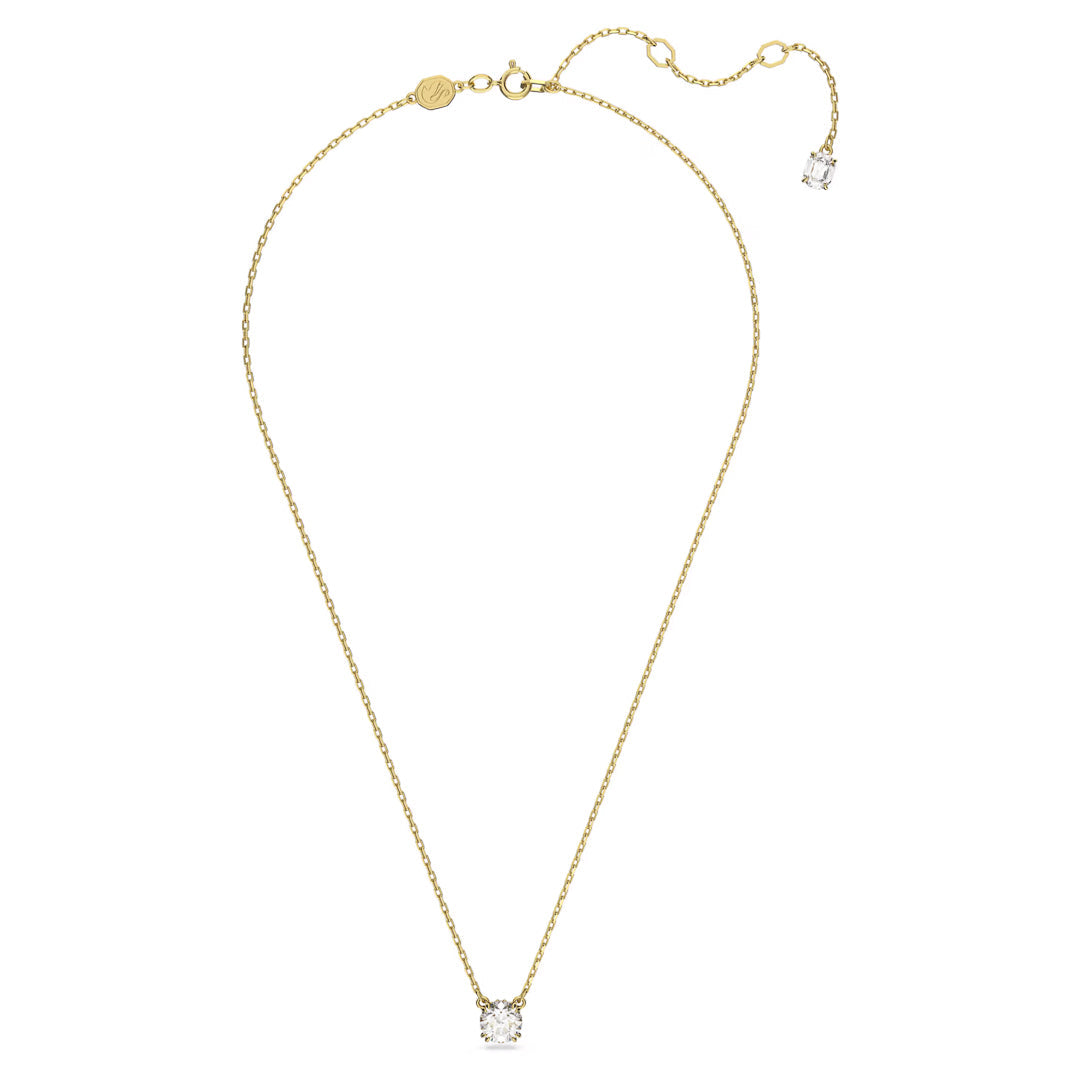 Introducing the Swarovski Stilla Necklace Pendant: a sophisticated gold-tone plated chain necklace featuring a petite, round zirconia pendant. It comes with an adjustable clasp adorned with an additional subtle diamond near the fastener, crafted by Swarovski.