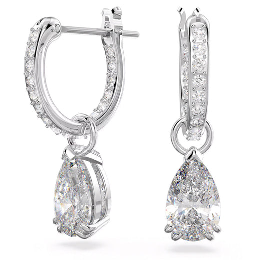 The Swarovski Stilla Hoop Earrings by Swarovski showcase two rhodium-plated silver hoops adorned with sparkling zirconia studs. Each earring is elegantly designed with a dangling pear-shaped diamond, enhancing their brilliance for an elegant and luxurious appearance.