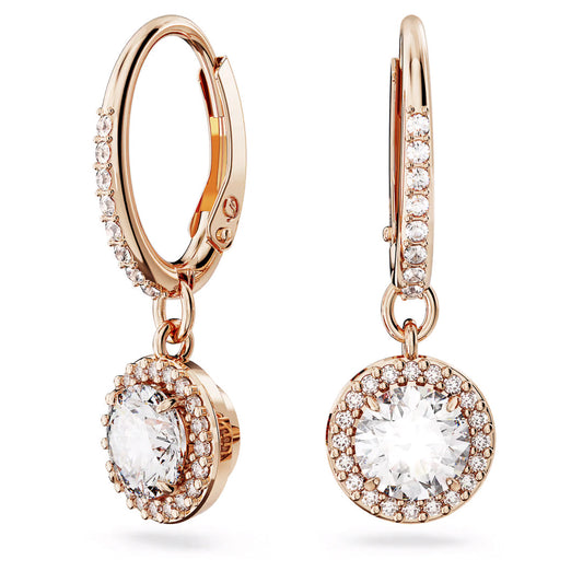 Introducing the Swarovski Una Angelic Drop Earrings by Swarovski, featuring elegant rose gold-tone hoops adorned with circular drop pendants. Each pendant boasts a large, sparkling white crystal surrounded by smaller gemstones, crafting a luxurious and sophisticated appearance.