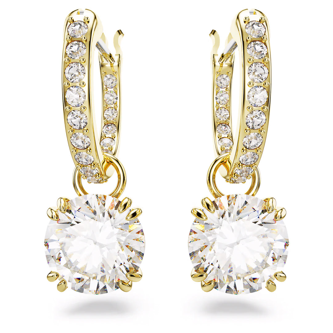Gold-tone plated hoop earrings from the Swarovski Stilla collection, featuring sparkling diamonds encrusting the hoops. Each earring showcases a large, round brilliant-cut diamond dangling gracefully from the hoop, set in gold prongs.