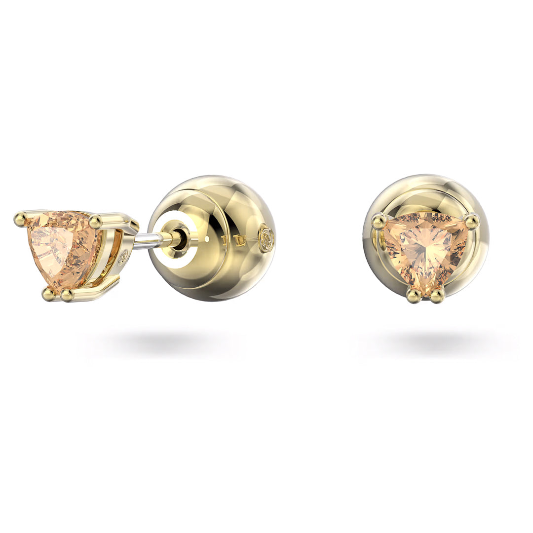 Introducing the Swarovski Chroma Stud Earrings by Swarovski: a pair of gold stud earrings adorned with trilliant-cut orange crystals in a prong setting. These earrings are securely fastened with push-back closures and showcase an elegant yet classic bold design.