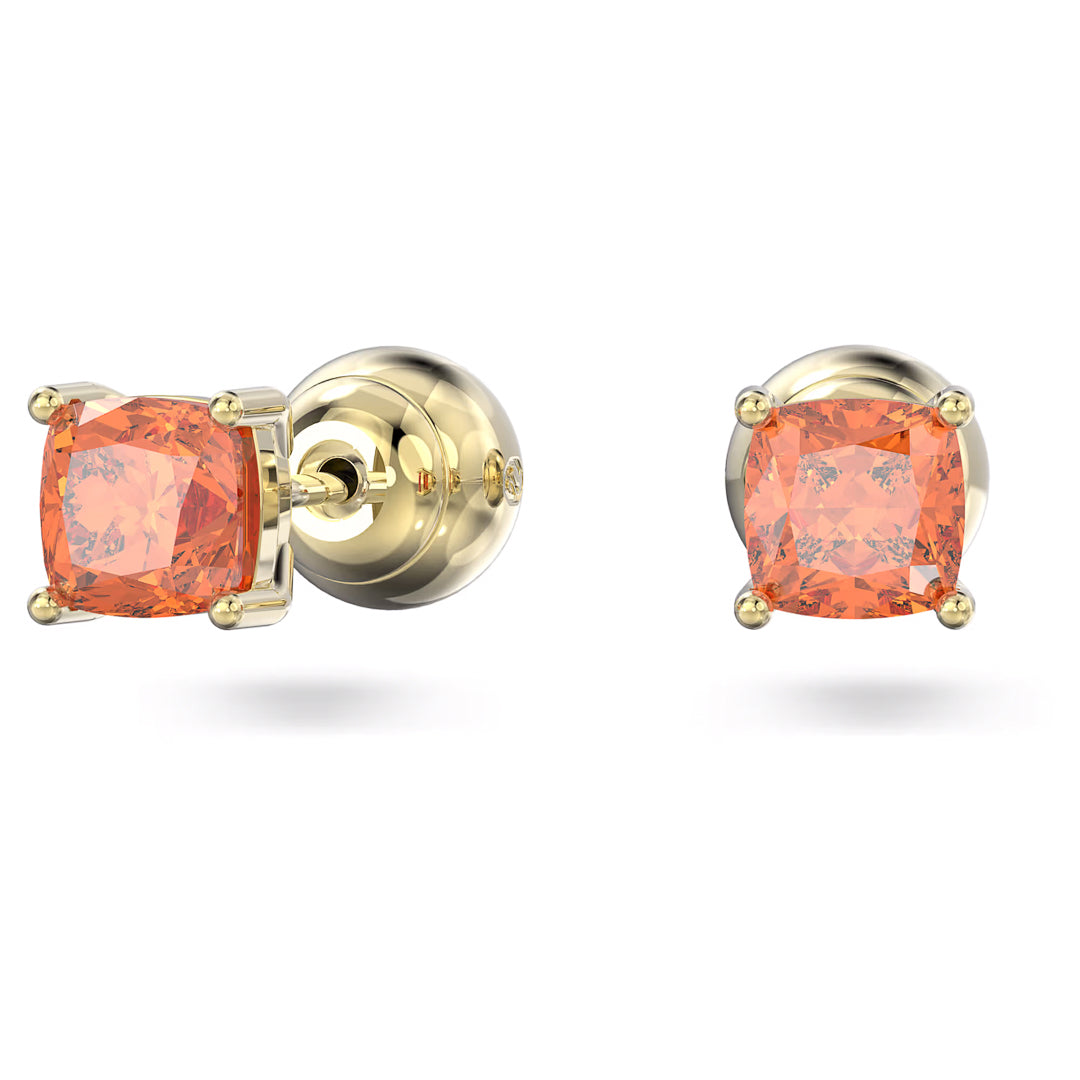 The Swarovski Chroma Stud Earrings, crafted by Swarovski, are a pair of stud earrings featuring cushion-cut orange gemstones set in gold-tone plating. They showcase four-prong settings and polished gold backings, all elegantly presented on a plain white background.