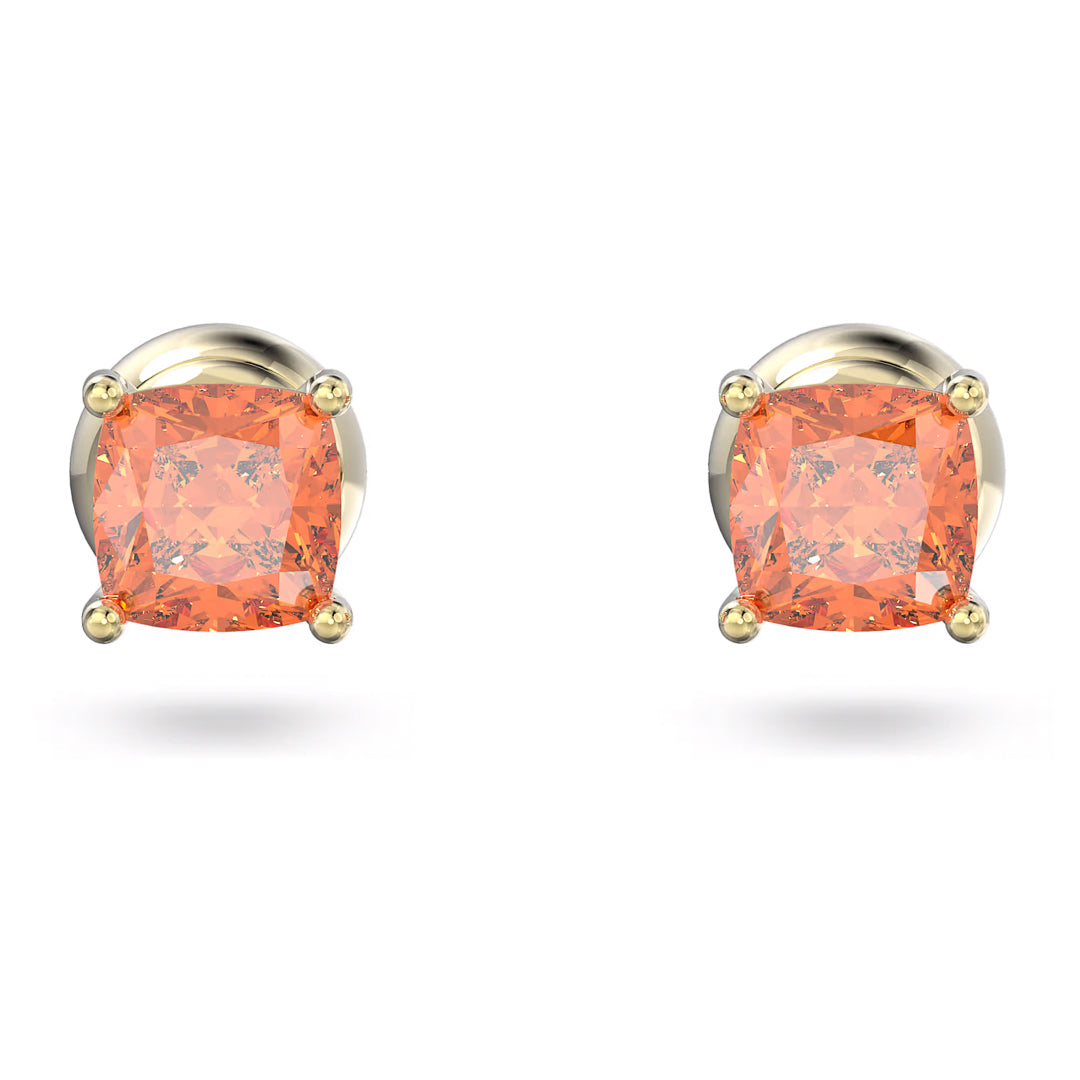 Close-up of the Swarovski Chroma Stud Earrings by Swarovski, featuring gold-tone plated studs with square-cut orange gemstones secured by four prongs. The earrings boast a simple and elegant design that showcases the vibrant color of the gemstones.