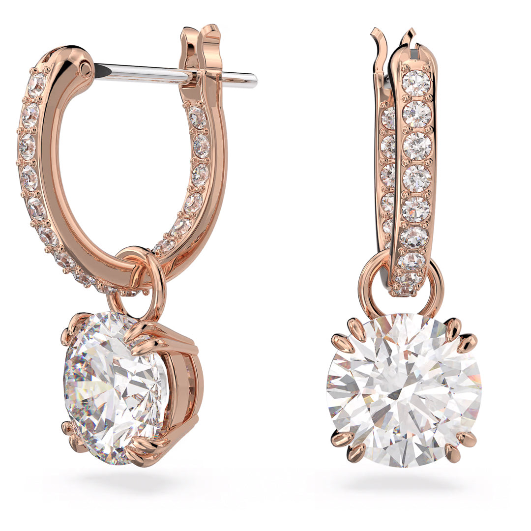 Introducing the Swarovski Stilla Drop Earrings from Swarovski, crafted in a rose gold-tone plating. These hoop earrings are embellished with delicate crystals and each features a stunning large round-cut diamond pendant. This elegant design exudes sophistication and shimmer.