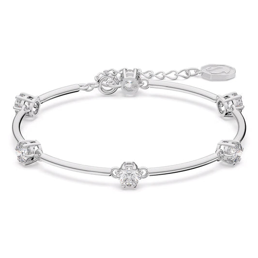 A silver bracelet with a delicate chain design, adorned with a series of clear, sparkling zirconia gemstones along its length. It's rhodium plated for additional shine and features an adjustable clasp alongside a small engraved tag that evokes the sophisticated charm of the Swarovski Constella Bangle.