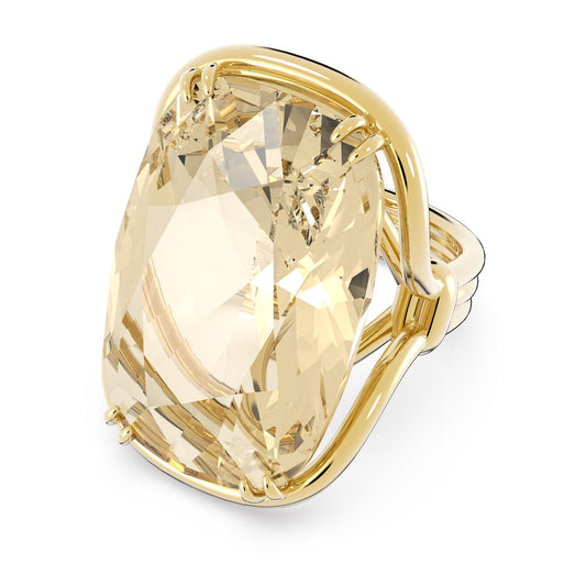 Introducing the Swarovski Gold Tone Harmonia Cocktail Ring, a breathtaking piece that showcases a large, cushion-cut golden-yellow gemstone elegantly set in a polished gold-tone plated band with a secure four-prong setting. This faceted gem brilliantly catches the light, creating an enchanting sparkle. Crafted by Swarovski, this ring is sure to make a dazzling statement.
