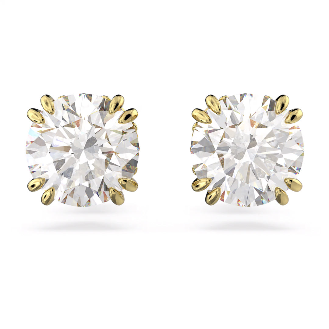 A pair of Swarovski Stilla stud earrings featuring round zirconia set in yellow gold prongs against a white background.