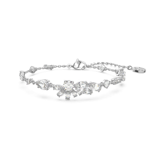 The Swarovski Mixed Cuts Gema Bracelet, from Swarovski, is a delicate silver accessory embellished with sparkling crystals and asymmetric floral motifs. This rhodium-plated piece features a chain with an adjustable clasp, adding a touch of elegance to any ensemble.