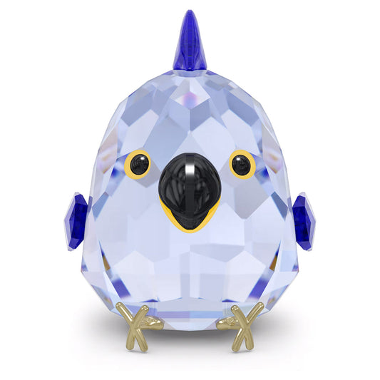 The Swarovski All you Need are Birds Blue Macaw Home Décor, by Swarovski, is a small and intricately designed crystal ornament featuring a faceted blue body, black eyes, and elegant gold accents on its beak and feet. With its cute round shape and pointed crest on its head, it's the perfect piece to add charm to your springtime decor.