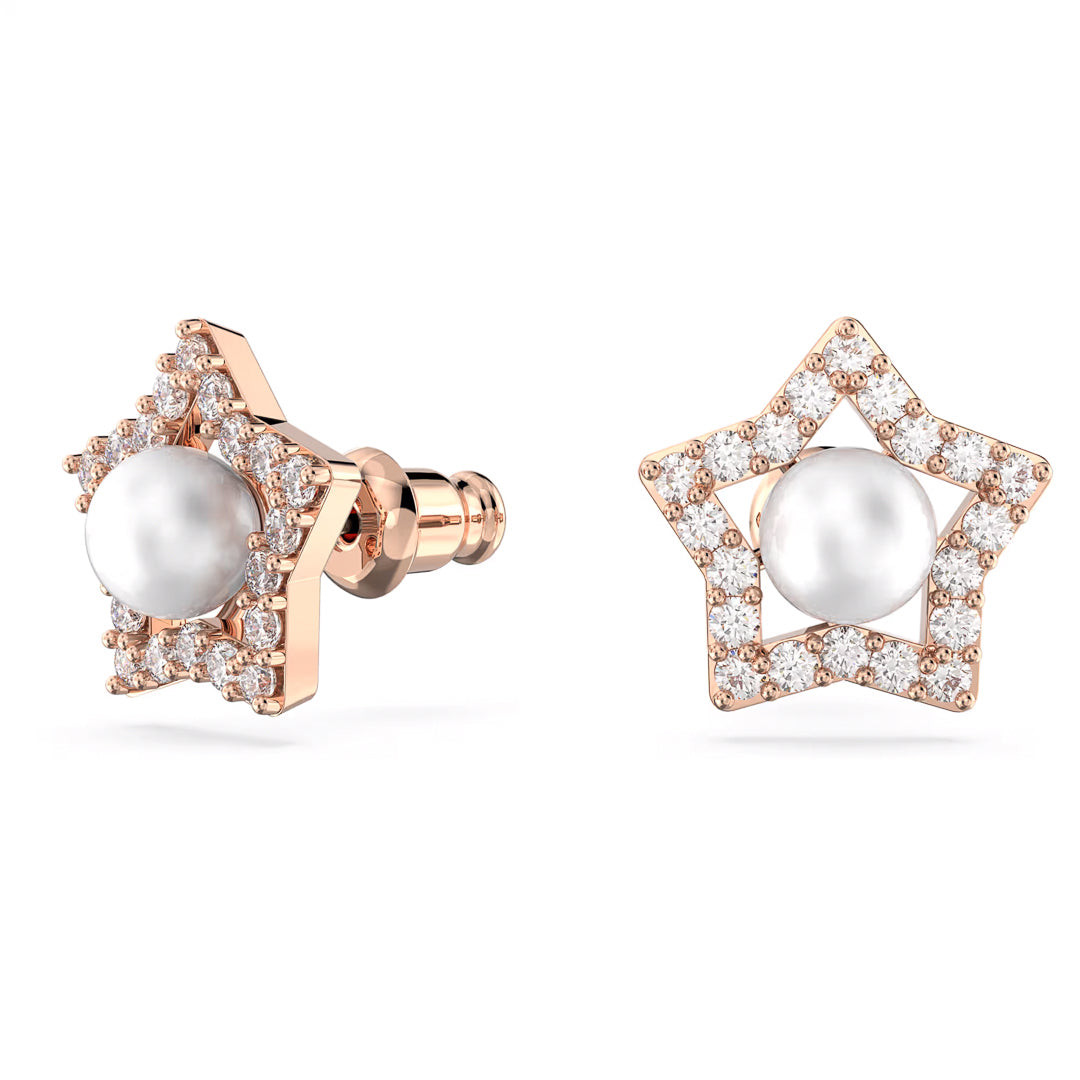 The Swarovski Stella Stud Earrings boast a stunning star-shaped design, enhanced by rose gold-tone plating, diamond accents, and a central crystal pearl. The unique design is showcased with one earring displayed from the side and the other facing forward against a plain background.