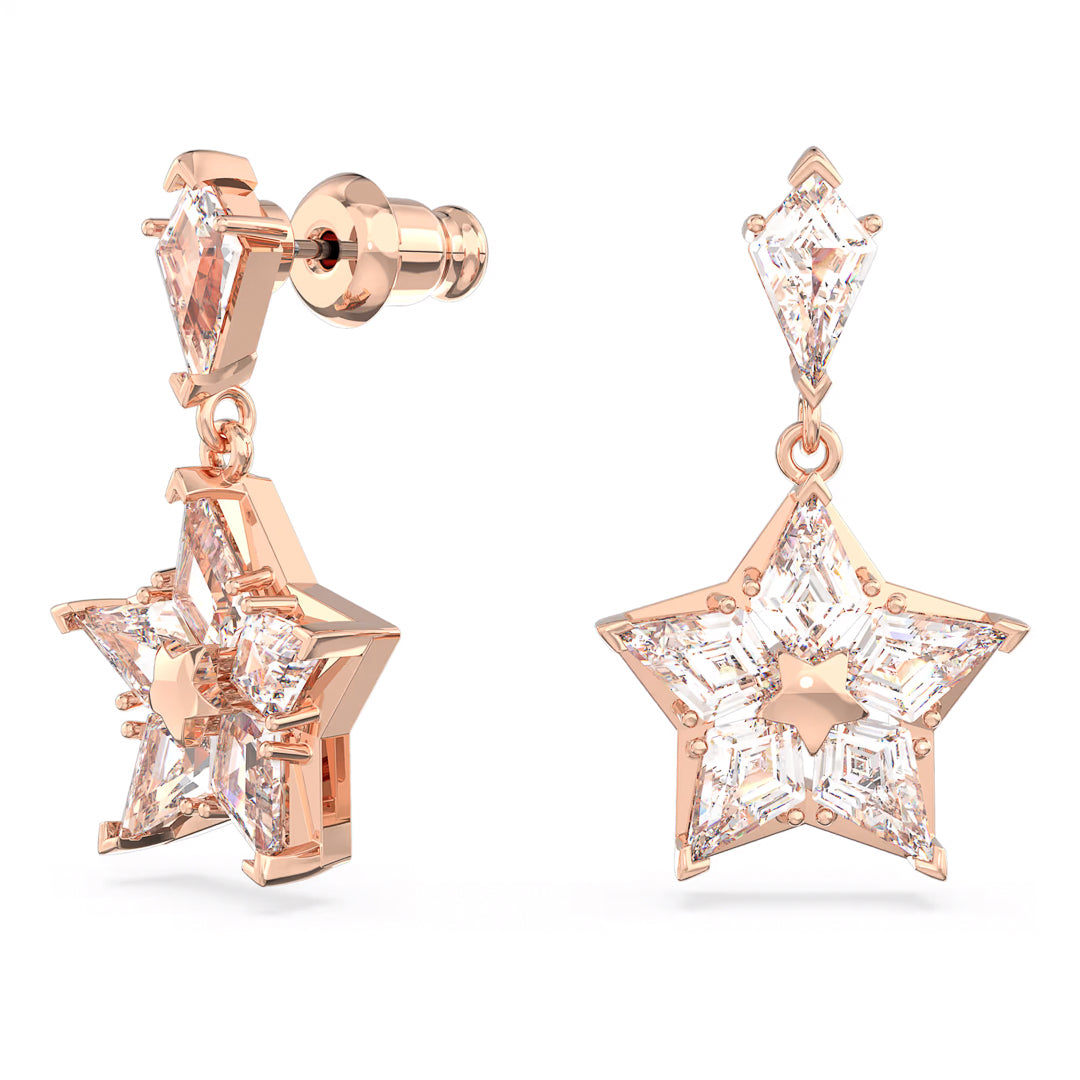 The Swarovski Stella Drop Earrings by Swarovski showcase a pair of rose gold-tone drop earrings with a dangling star-shaped design adorned with clear, faceted gemstones. Each piece features a smaller, kite-shaped Zirconia that links the star to the stud, enhancing their shiny and elegant appearance.